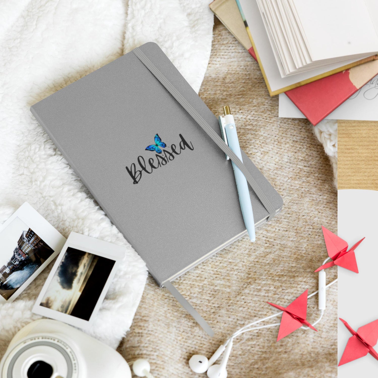 Hardcover bound notebook in a grey color with a minimalist design, featuring the word 'Blessed' elegantly printed on the cover.