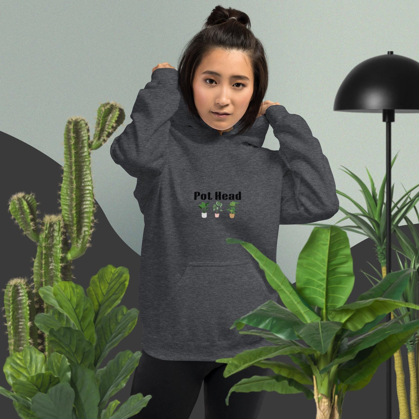 Dark heather colored hoodie designed for plant lovers, featuring the phrase 'Pot Head' in bold black text above the front pouch pocket, complemented by a decorative plant design