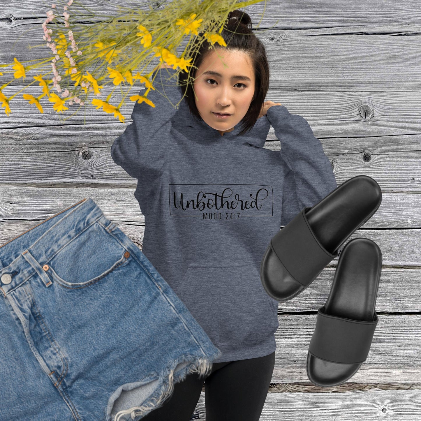 Heather sport dark navy colored unisex hoodie featuring the word 'Unbothered,' serving as a reminder not to stress over things outside of your control.