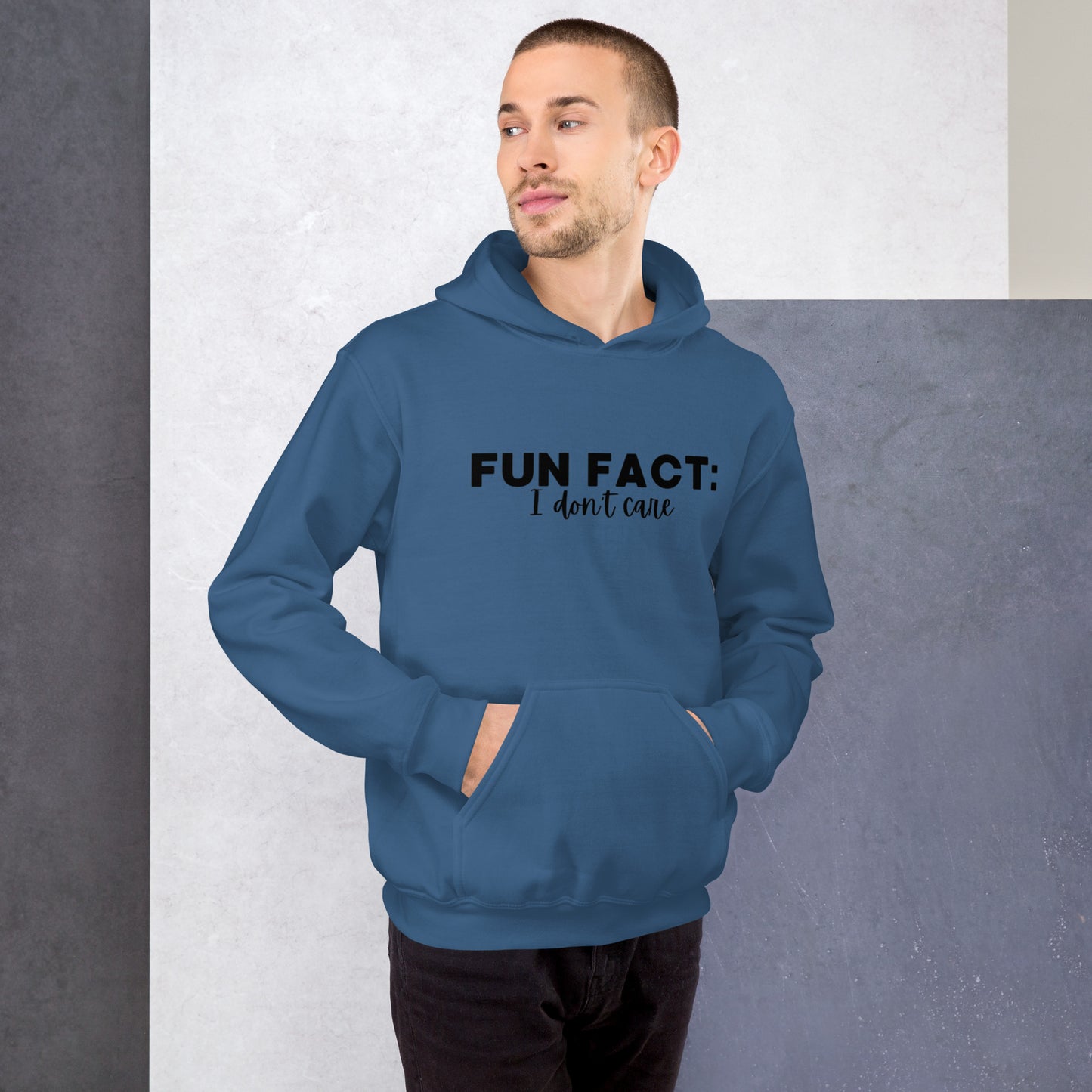 Indigo blue colored unisex hoodie featuring the phrase 'Fun Fact: I Don't Care' in bold black writing on the front above the front pouch pocket.