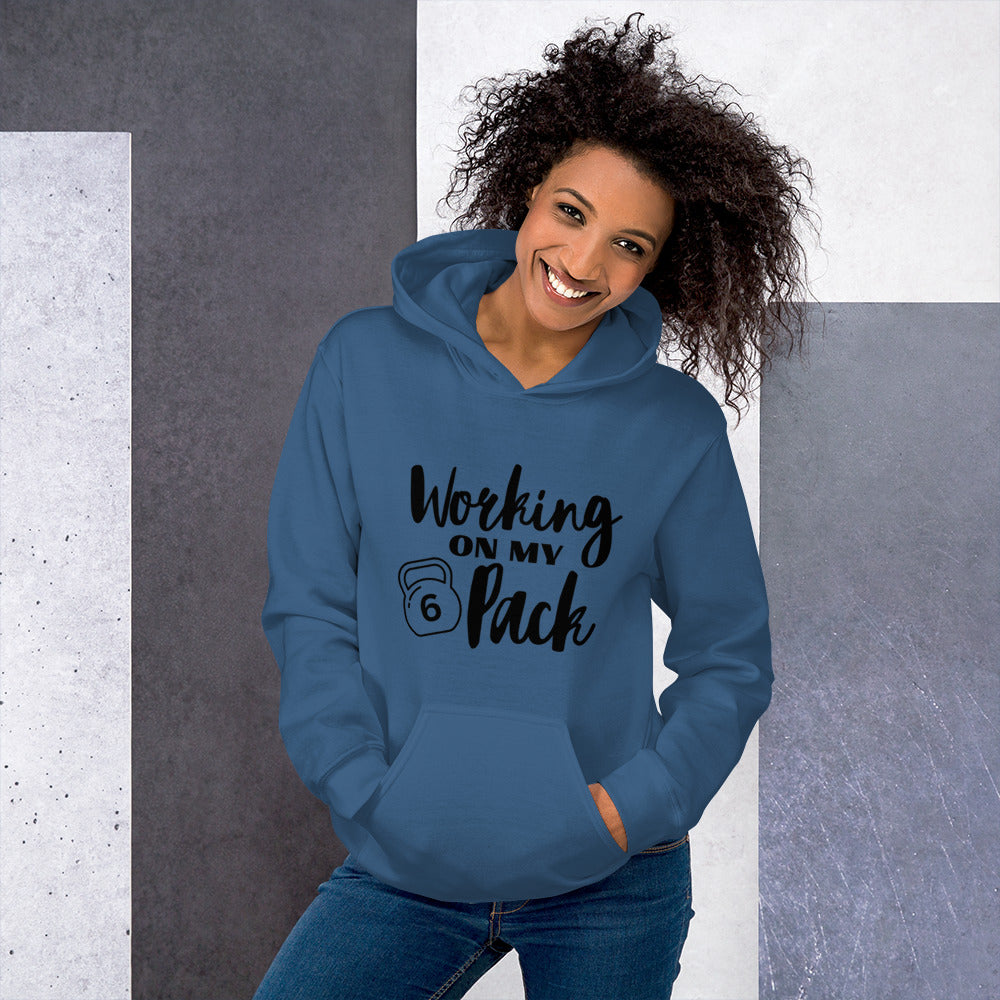 Indigo blue colored unisex hoodie featuring the phrase 'Working on my 6 Pack' in black font. This cozy hoodie is perfect for the gym or evening walks.