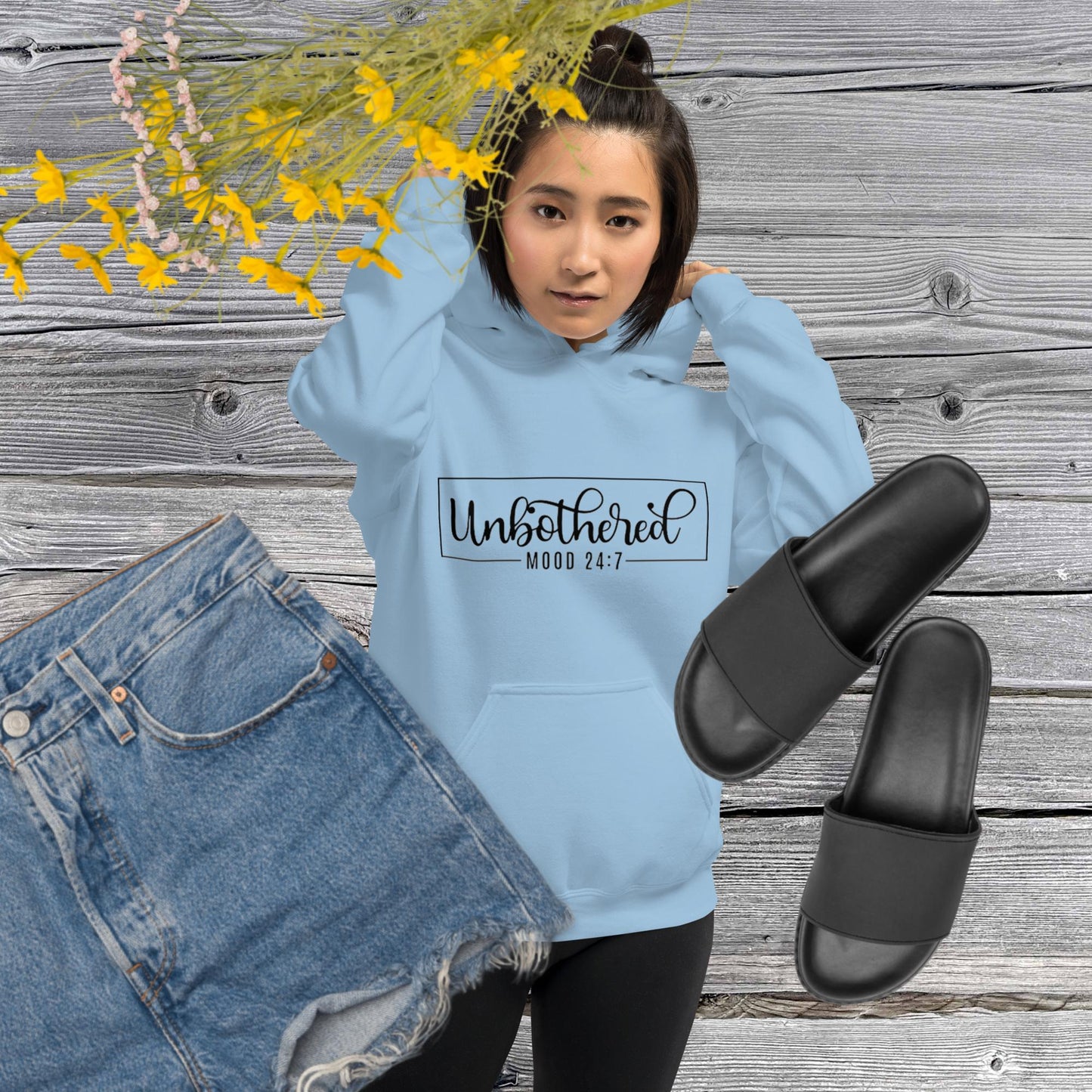 Light blue colored unisex hoodie featuring the word 'Unbothered,' serving as a reminder not to stress over things outside of your control.