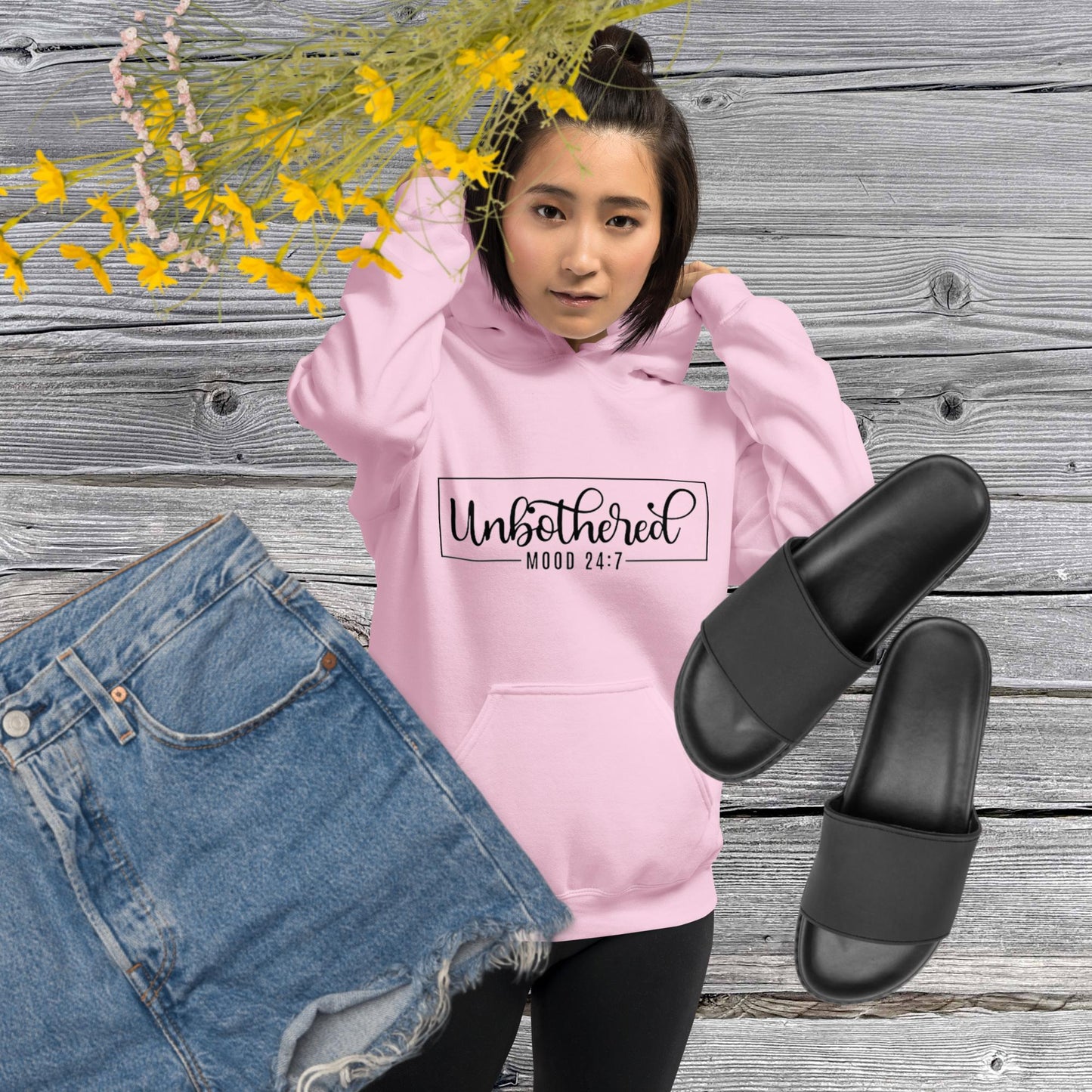 Light pink colored unisex hoodie featuring the word 'Unbothered,' serving as a reminder not to stress over things outside of your control.