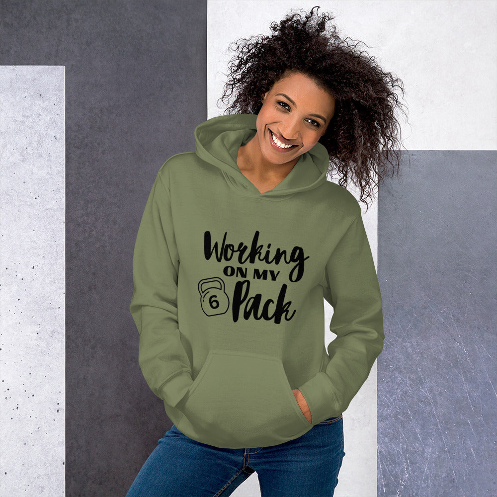 Military green colored unisex hoodie featuring the phrase 'Working on my 6 Pack' in black font. This cozy hoodie is perfect for the gym or evening walks.