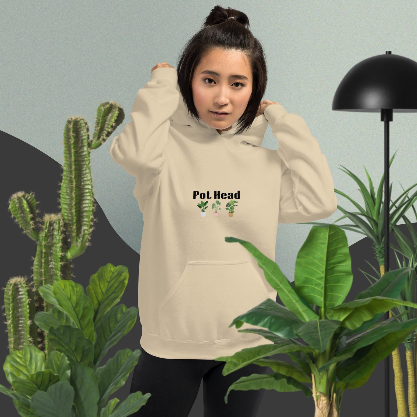 Sand colored hoodie designed for plant lovers, featuring the phrase 'Pot Head' in bold black text above the front pouch pocket, complemented by a decorative plant design