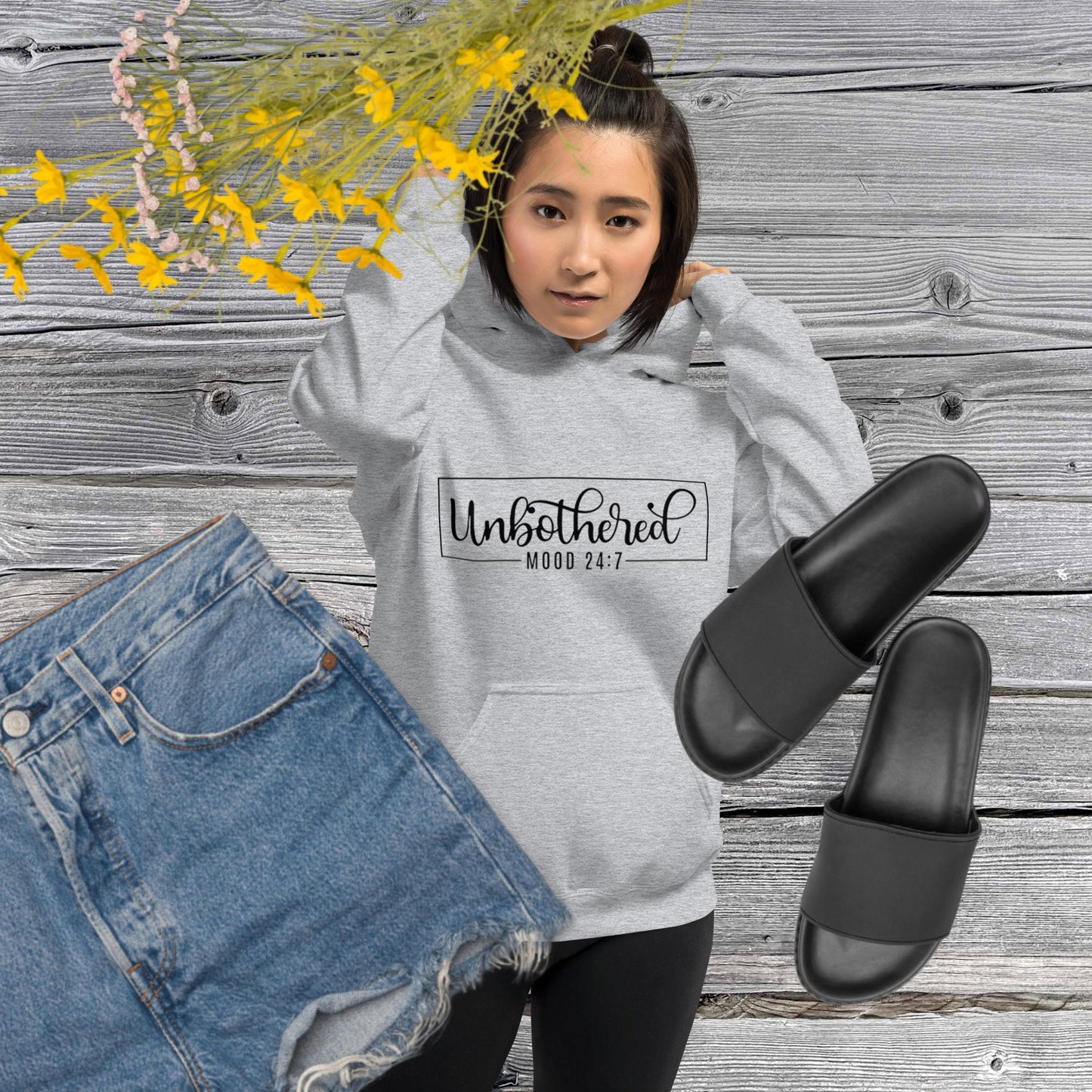 Sport grey colored unisex hoodie featuring the word 'Unbothered,' serving as a reminder not to stress over things outside of your control.