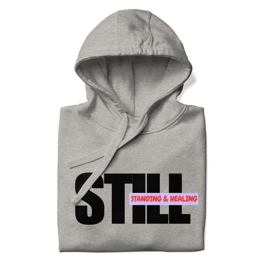 Unisex hoodie with the words 'Still Standing and Healing' printed boldly across the chest. A powerful and empowering self-reminder that your past does not define you, symbolizing resilience, growth, and the journey toward a brighter future. Perfect for anyone embracing their healing journey with strength and courage.